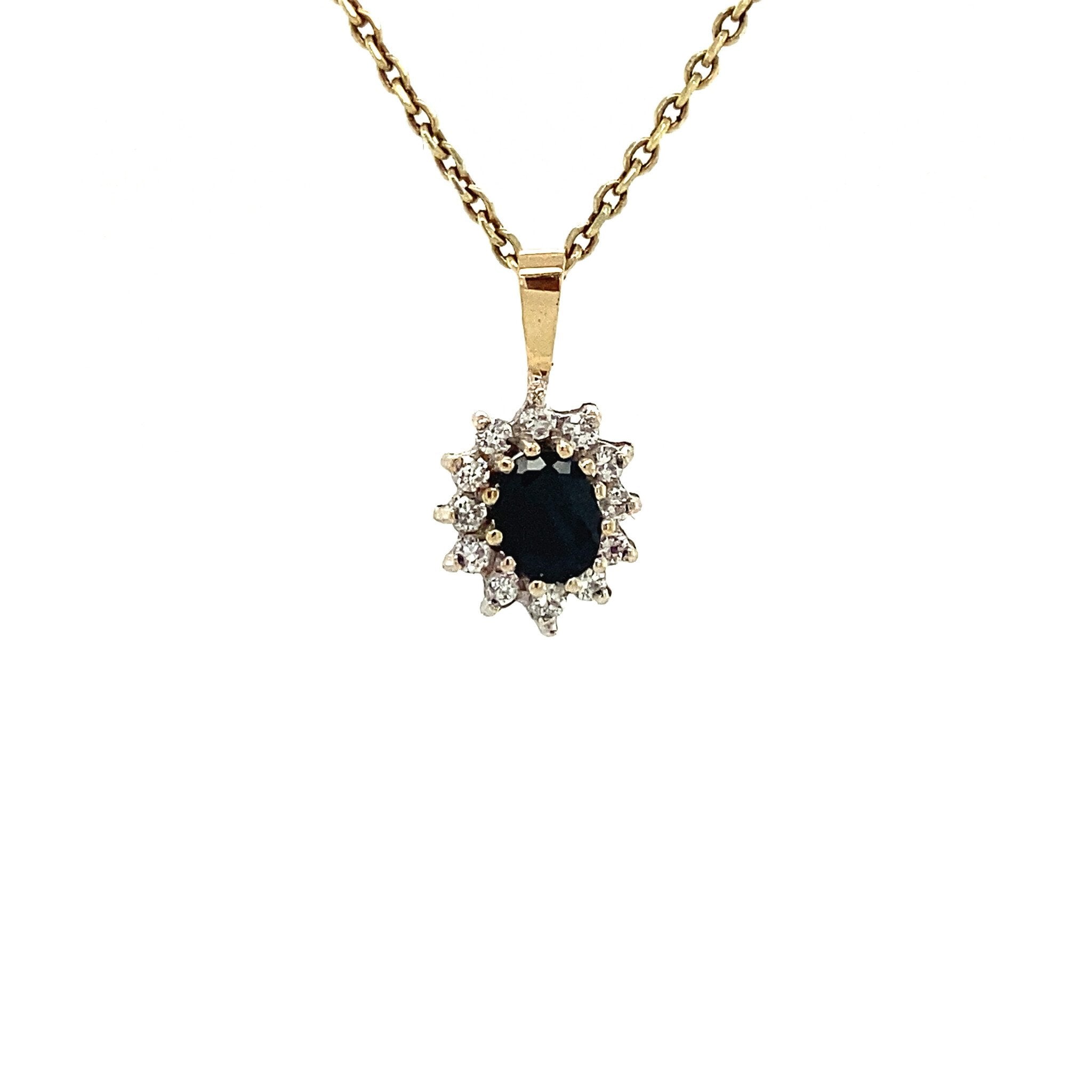 14 kt gold entourage pendant with sapphire and zirconia