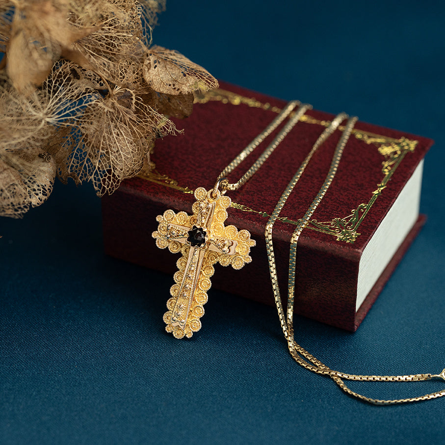 14 kt gold cross pendant with garnet