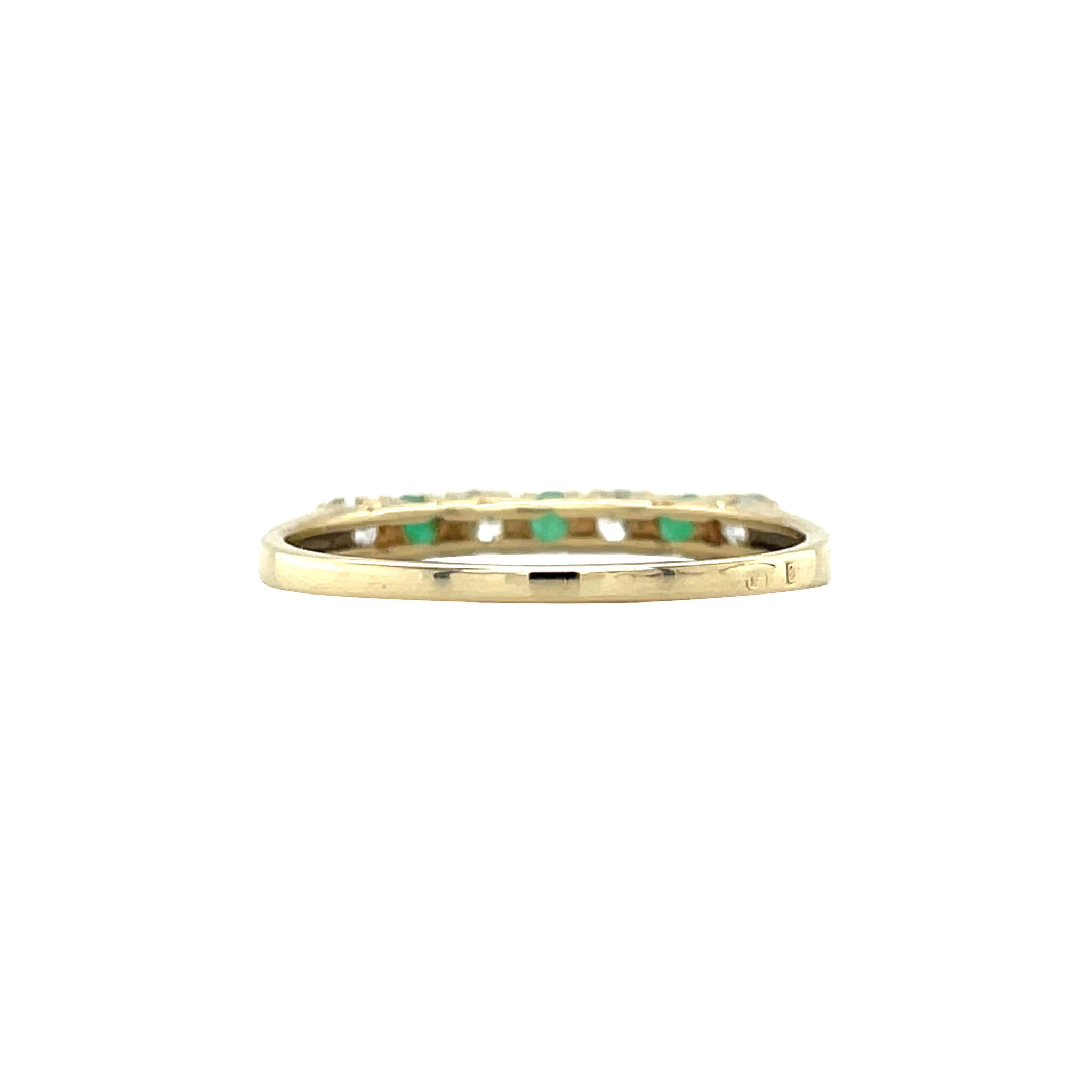 14 kt gold row ring with emerald and zirconia