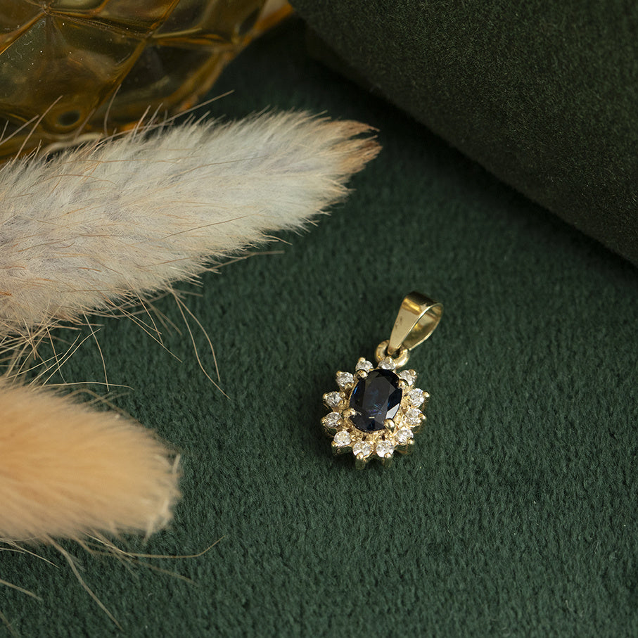 Vintage 14 kt gold entourage pendant with sapphire and zirconia