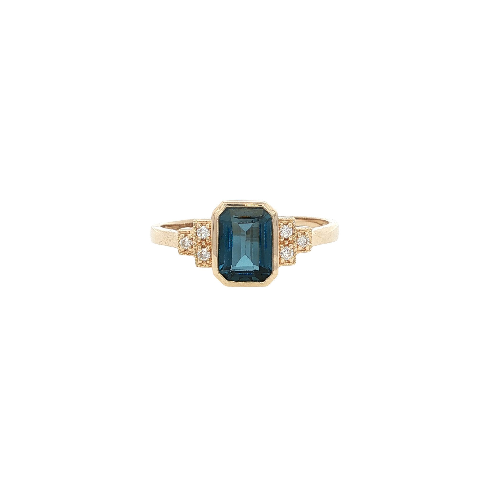 Gouden ring met blauwe topaas en diamant 14 kt