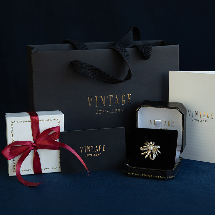 Gouden vintage strik broche met diamant 14 krt