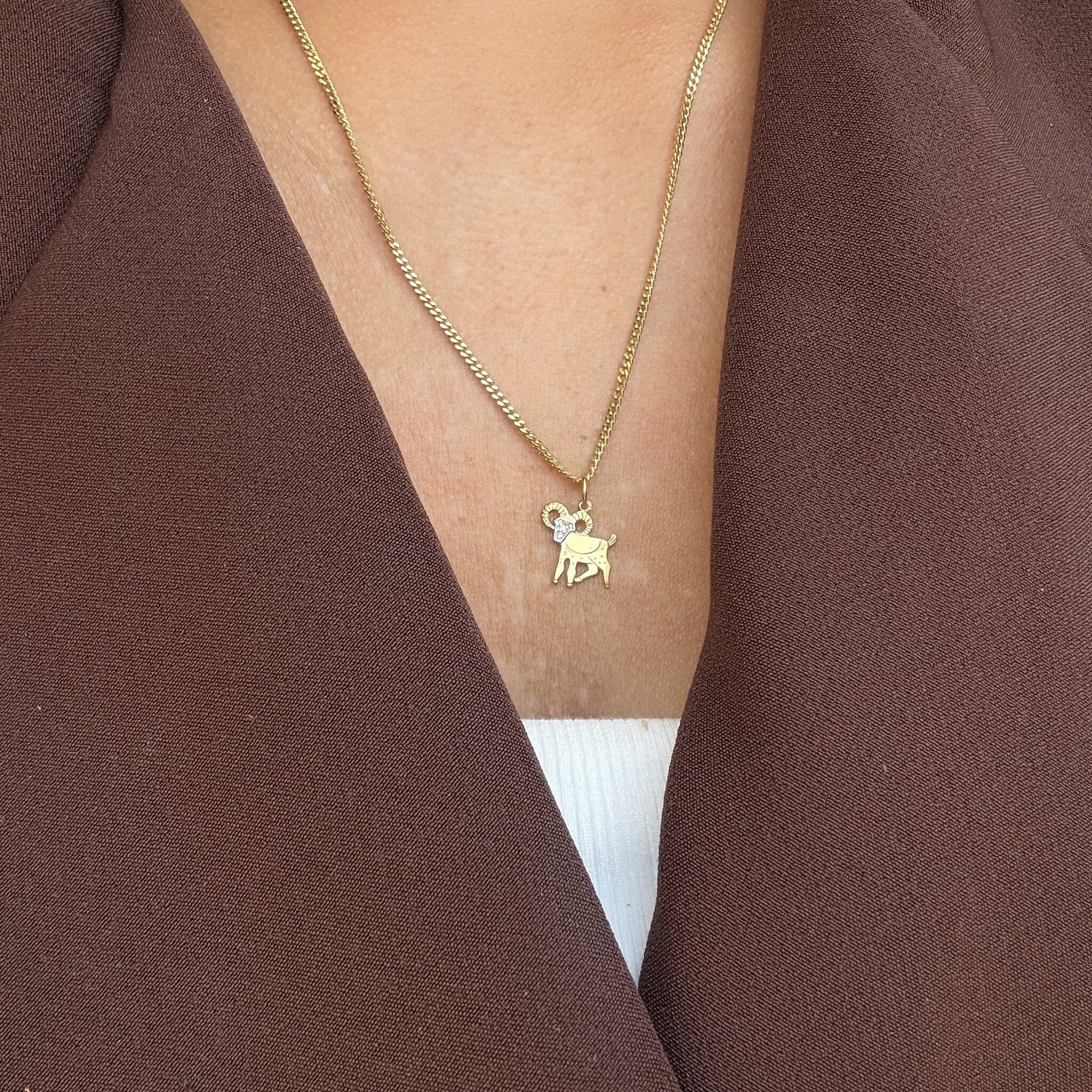 Vintage 14 kt gold ram pendant with diamond