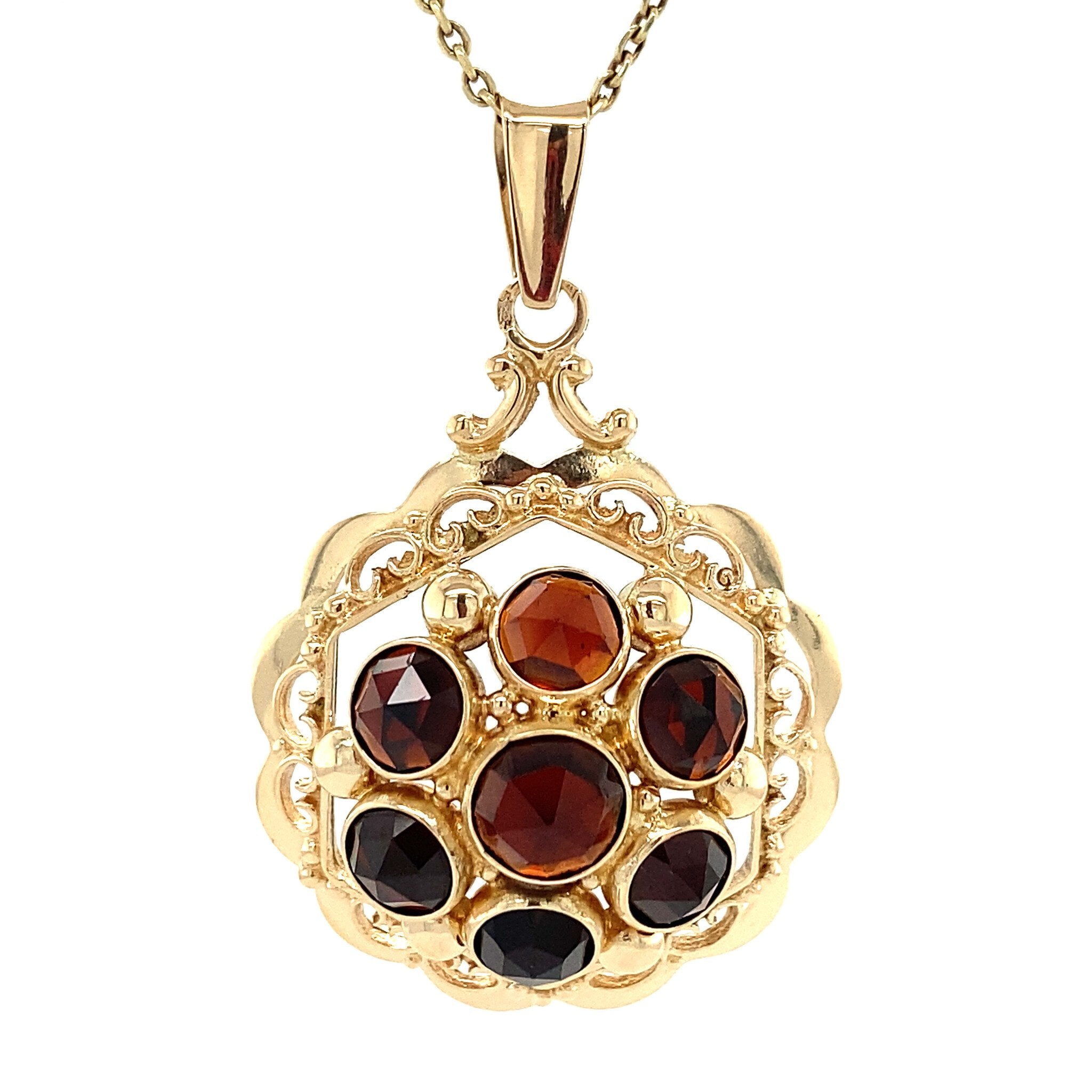 Gold entourage pendant with garnet 14 kt