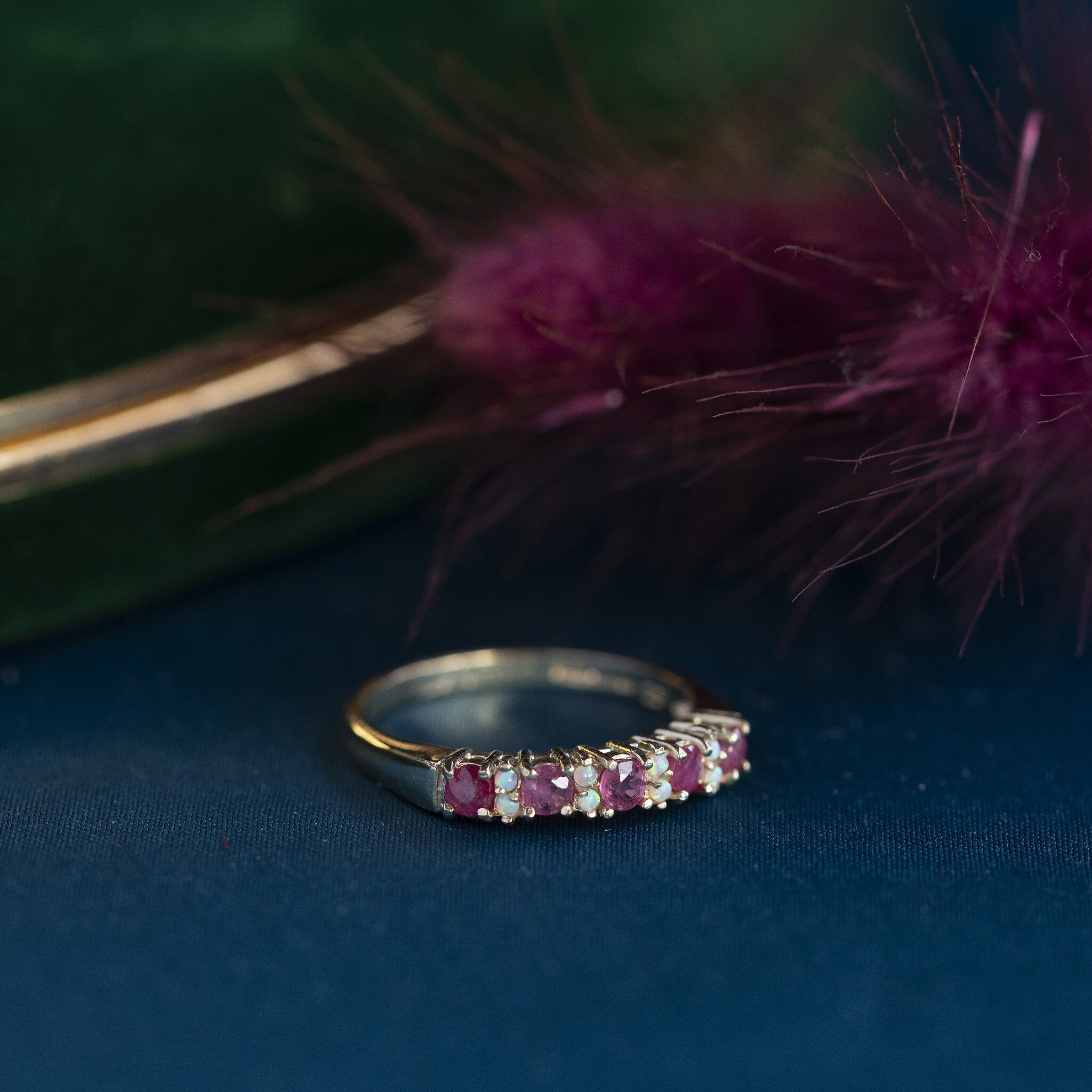 Row ring with opal and ruby 9 krt