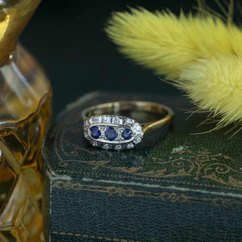 18 kt vintage gold entourage ring with sapphire and diamond