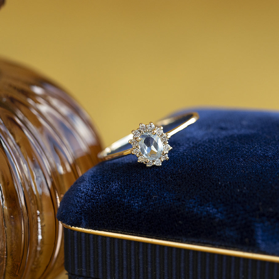 Vintage gold entourage ring with aquamarine and diamond, 14 kt