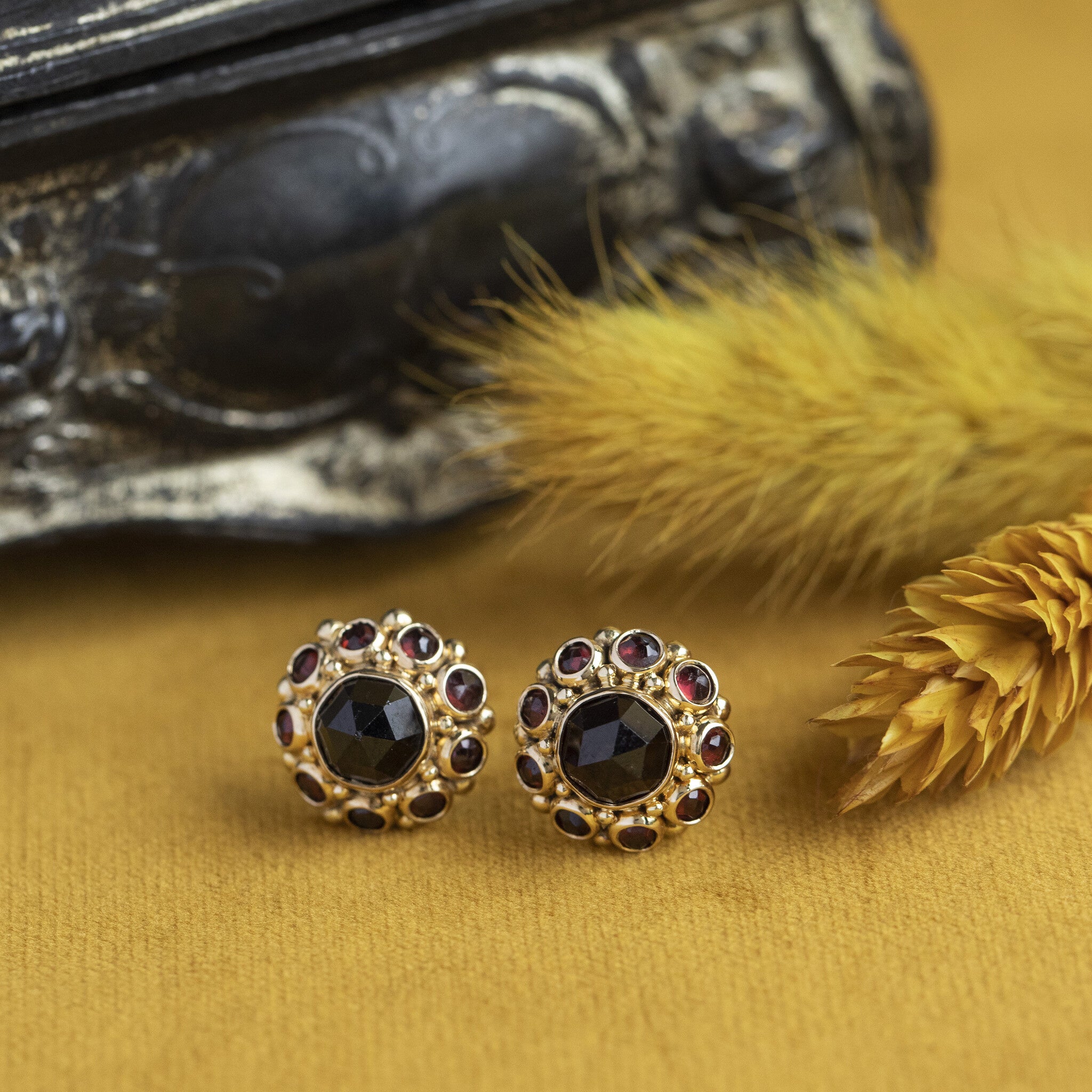 Gold entourage ear studs with garnet 14 krt