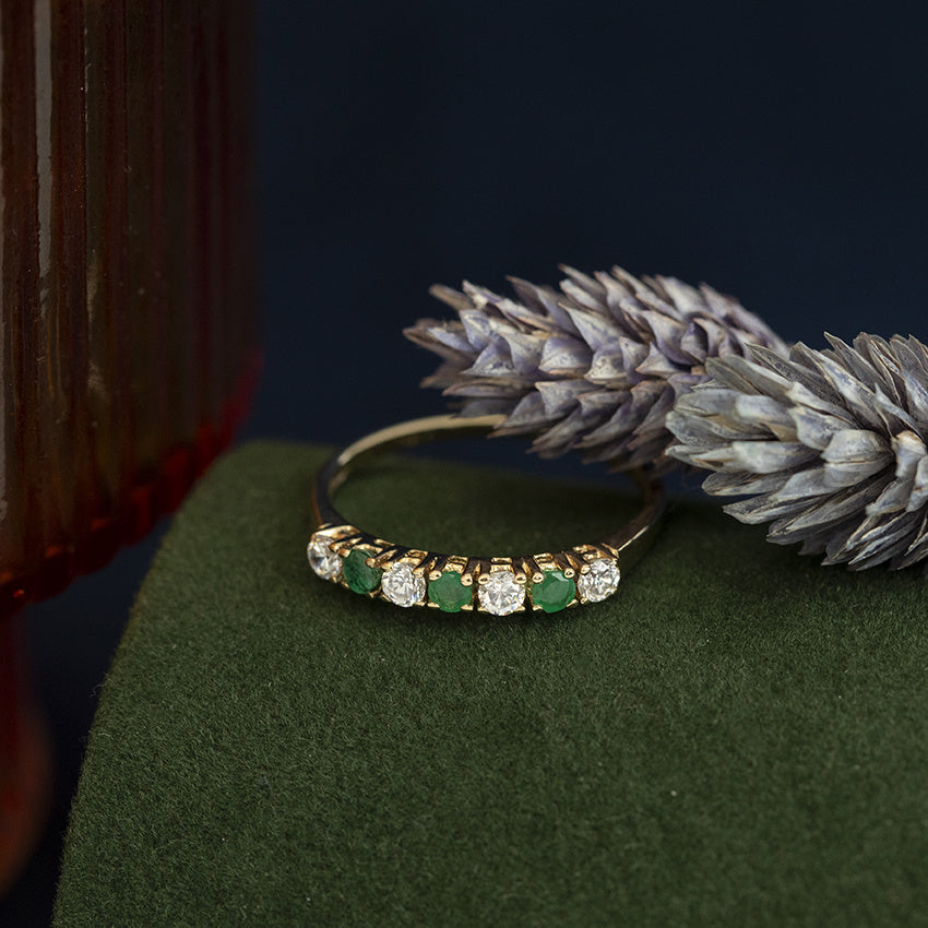 14 kt gold row ring with emerald and zirconia