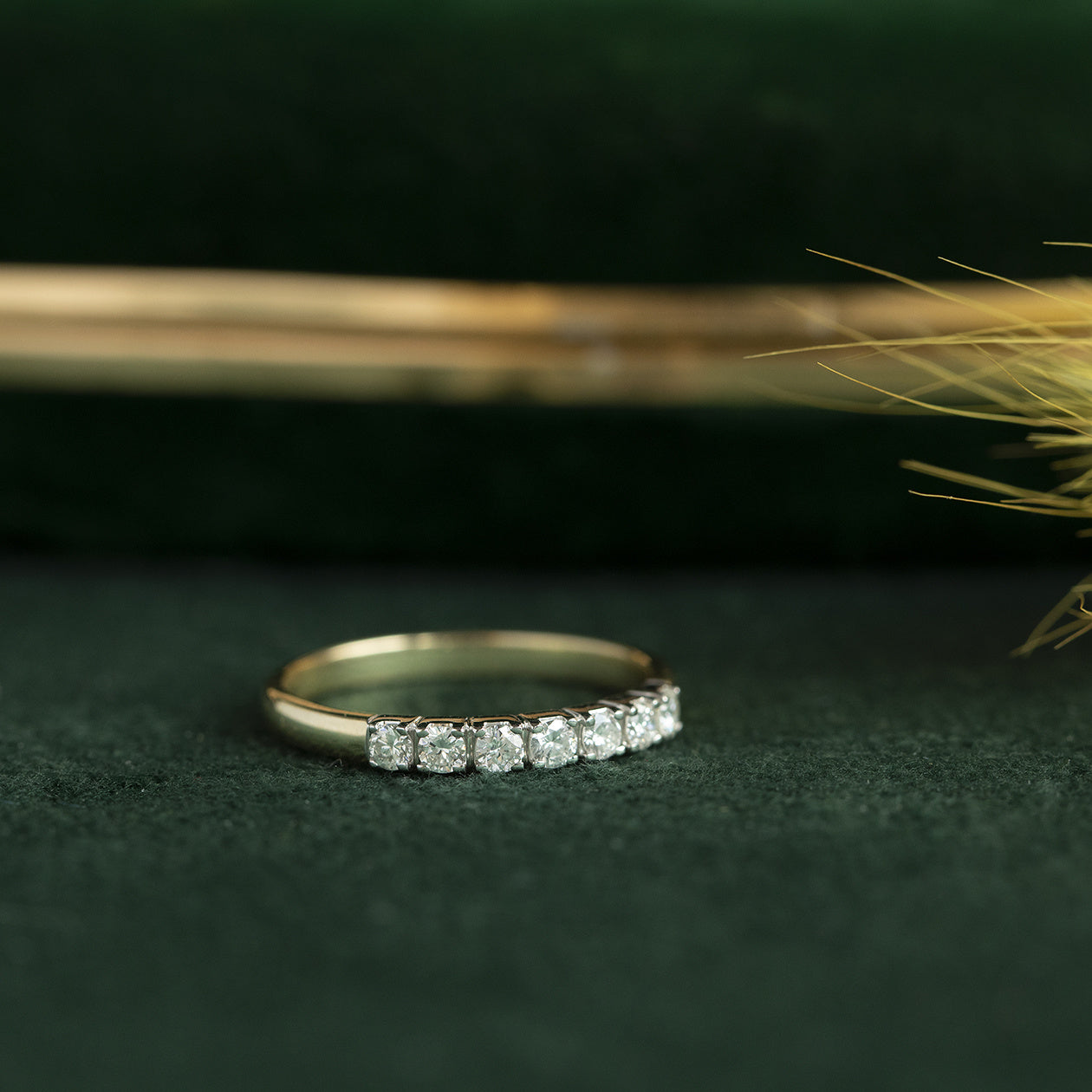 14 kt gold row ring with a diamond.