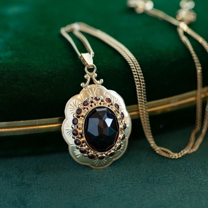 Gouden entourage hanger met granaat 14 krt