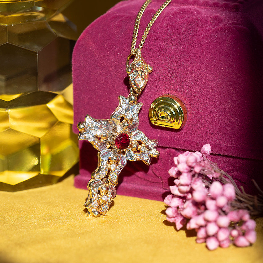 12 kt two-tone cross pendant with ruby and zirconia
